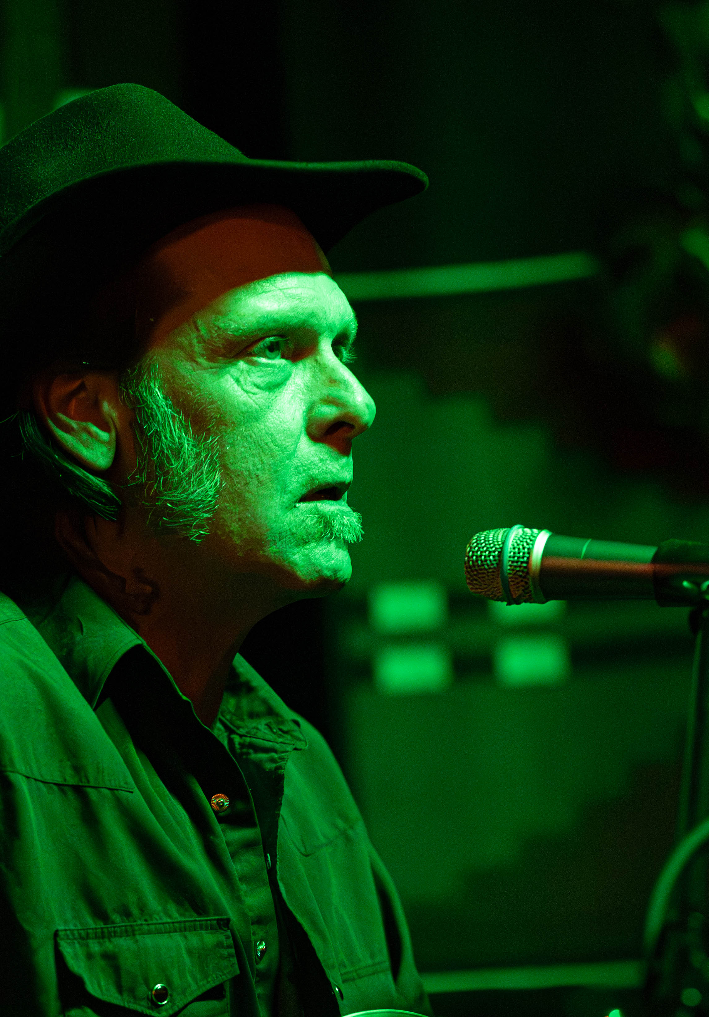Green-lit portrait from a different angle